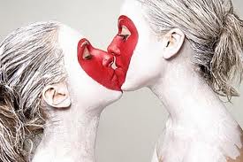 two ladies, side on and close up: red heart superimposed in red make up